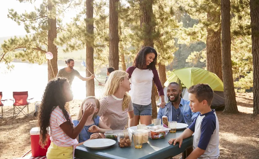 People sitting at a picnic table.